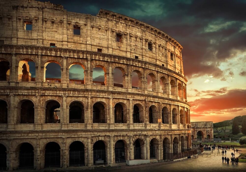 One of the most popular travel place in world – Roman Coliseum under evening sun light and sunrise sky.